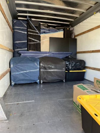 Inside of a moving truck loaded with wrapped furniture for residential moving